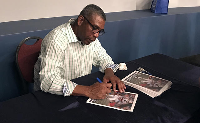 Raymond Clayborn signs autographs for fans after his speaker series at The Patriots Hall of Fame presented by Raytheon.